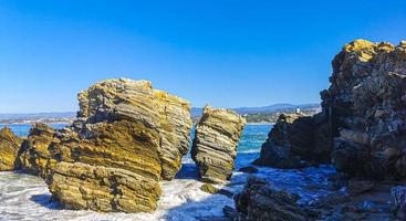 Beautiful rocks cliffs surfer waves at beach Puerto Escondido Mexico. photo