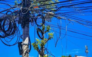 Absolute cable chaos on Thai power pole in Mexico. photo