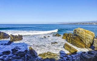 Beautiful rocks cliffs surfer waves at beach Puerto Escondido Mexico. photo