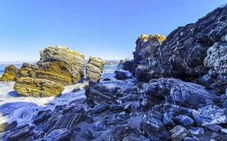 Beautiful rocks cliffs surfer waves at beach Puerto Escondido Mexico. photo