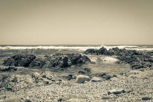 Strong waves, stones sea cliffs, Sea Point promenade Cape Town. photo