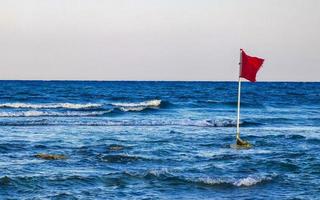 Red flag swimming prohibited high waves Playa del Carmen Mexico. photo