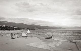 Wonderful sand and rocky beach and promenade Novi Vinodolski Croatia. photo