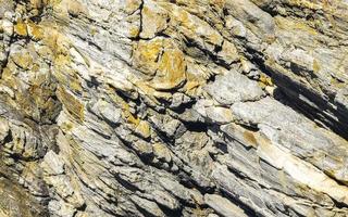 Beautiful rock cliff stone boulder texture pattern beach in Mexico. photo