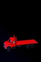 Toy truck on black background photo