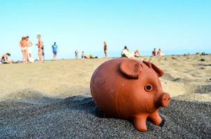 Piggy bank in the sand photo