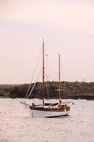 Sailing boat in a bay photo