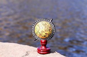 Globe on a rock photo