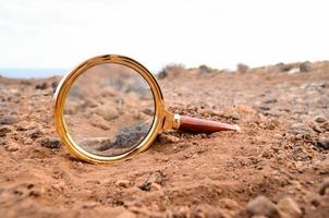Magnifying glass on the ground photo