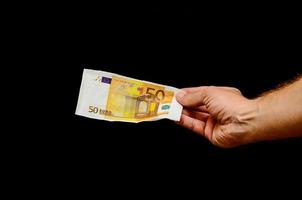 Hand holding Euro banknotes photo