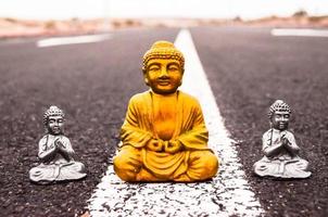 Small Buddha statues on the road photo