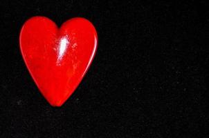 Red heart on black background photo