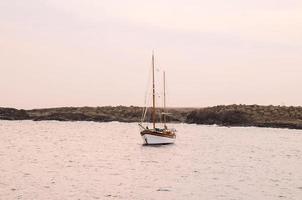 Sailing boat at the shore photo