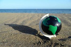 Globe on the beach photo