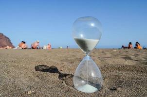 reloj de arena en la playa foto