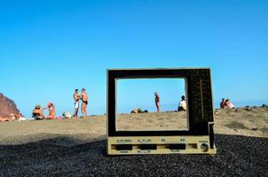 Old television in the sand photo