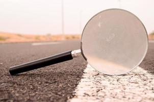 Magnifying glass on the road photo