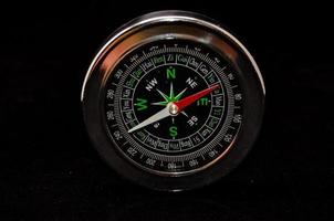 Isolated compass on black background photo
