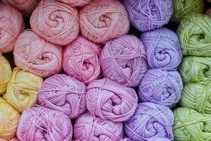 Yarns or balls of wool on shelves in store for knitting photo