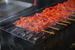 Close up retro Grill chicken stick on the Charcoal stove at street food stall thailand photo