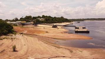 Aerial view of the Rio Negro and the passenger boat loading dock in Novo Airao, Brazil video