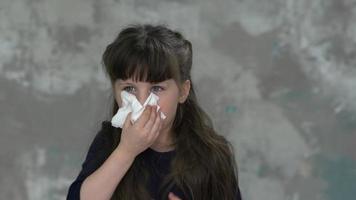 Unhappy child coughing, sneezing into a handkerchief, not his hand. Boy properly cover mouth when coughing. video