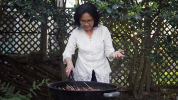 Woman Smiling While Grilling video
