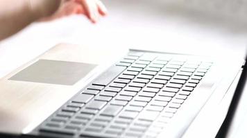 Mother and her son working up on laptop.European people.Hands close up. video