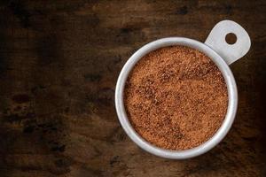 Ground Nutmeg in a Measuring Cup photo