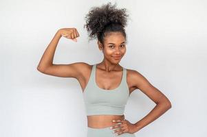young african woman showing arms muscles photo