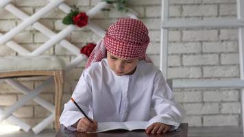 Little boy studying at school,writing. video