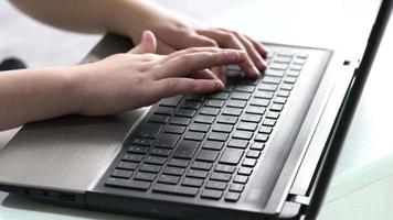 Hands of child on computer keyboard. Close up video