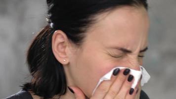 Young woman sneezing. Studio shot. video