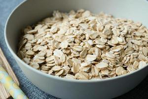 Close up of roasted oats flakes in a bowl on table photo