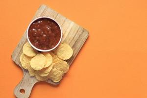 top view of chips and salsa on table , photo