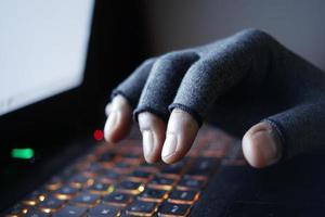 hacker hand stealing data from laptop top down photo