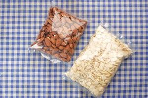 top view of almond nuts in a plastic packet on table photo