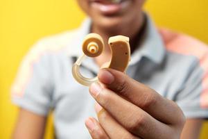 Hearing aid concept, teenage boy with hearing problems. photo