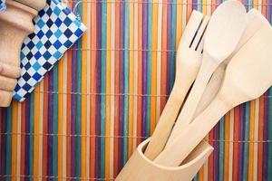 wooden cutlery fork and spoon on a chopping board on table photo