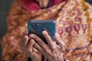 senior women hand using smart phone close up photo
