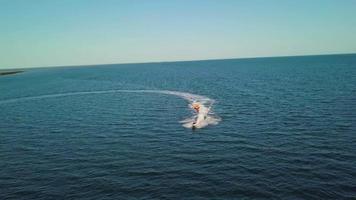 A motor boat takes tourists on the sea waves. video