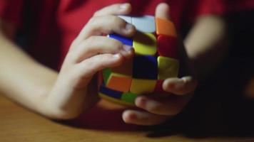 Close up view of kid enjoying Rubik's cube at home video