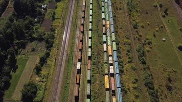 Flying above industrial railroad station with cargo trains video