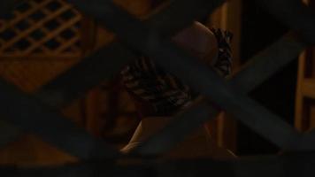 A Muslim Boy sitting in front of the bamboo pattern wall inside the traditional bamboo house at night video