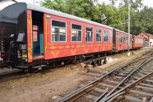 View of Toy train coach from the middle of railway track during daytime near Kalka railway station in India, Toy train coach view, Indian Railway junction, Heavy industry photo