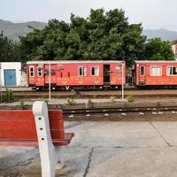 View of Toy train coach from the middle of railway track during daytime near Kalka railway station in India, Toy train coach view, Indian Railway junction, Heavy industry photo