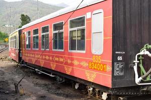 View of Toy train coach from the middle of railway track during daytime near Kalka railway station in India, Toy train coach view, Indian Railway junction, Heavy industry photo