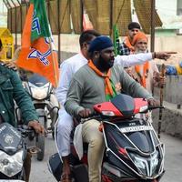 Delhi, India, December 02 2022 -Bharatiya Janata Party BJP supporter during mega road show in support of BJP candidate Pankaj Luthara to file nomination papers ahead of MCD local body Elections 2022 photo