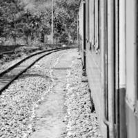 Toy Train moving on mountain slope, beautiful view, one side mountain, one side valley moving on railway to the hill, among green natural forest. Toy train from Kalka to Shimla in India photo