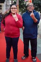 New Delhi, India - December 04 2022 - Unidentified people showing their ink-marked fingers after casting votes in front of polling booth of east Delhi area for MCD local body Elections 2022 photo